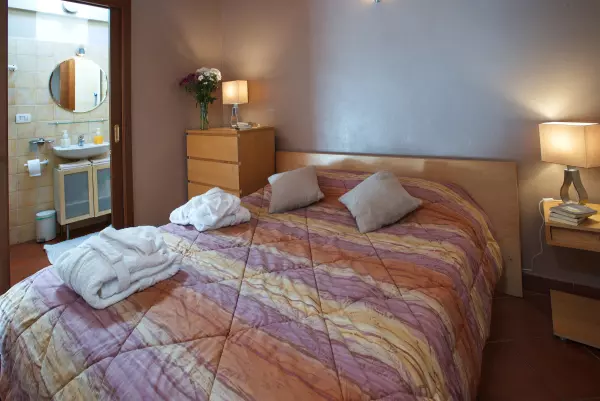 The bedroom with the double bed and bedside tables