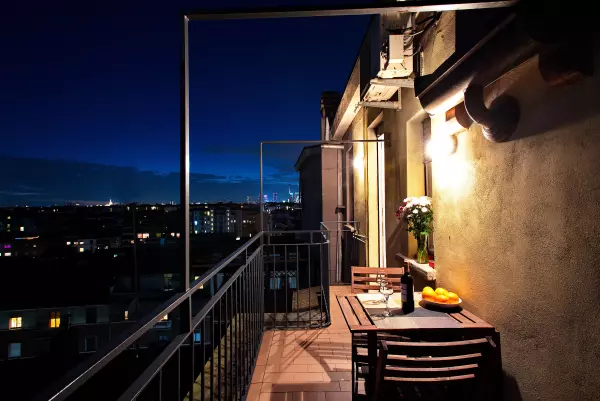 Table set with wine and fruit on the terrace at night